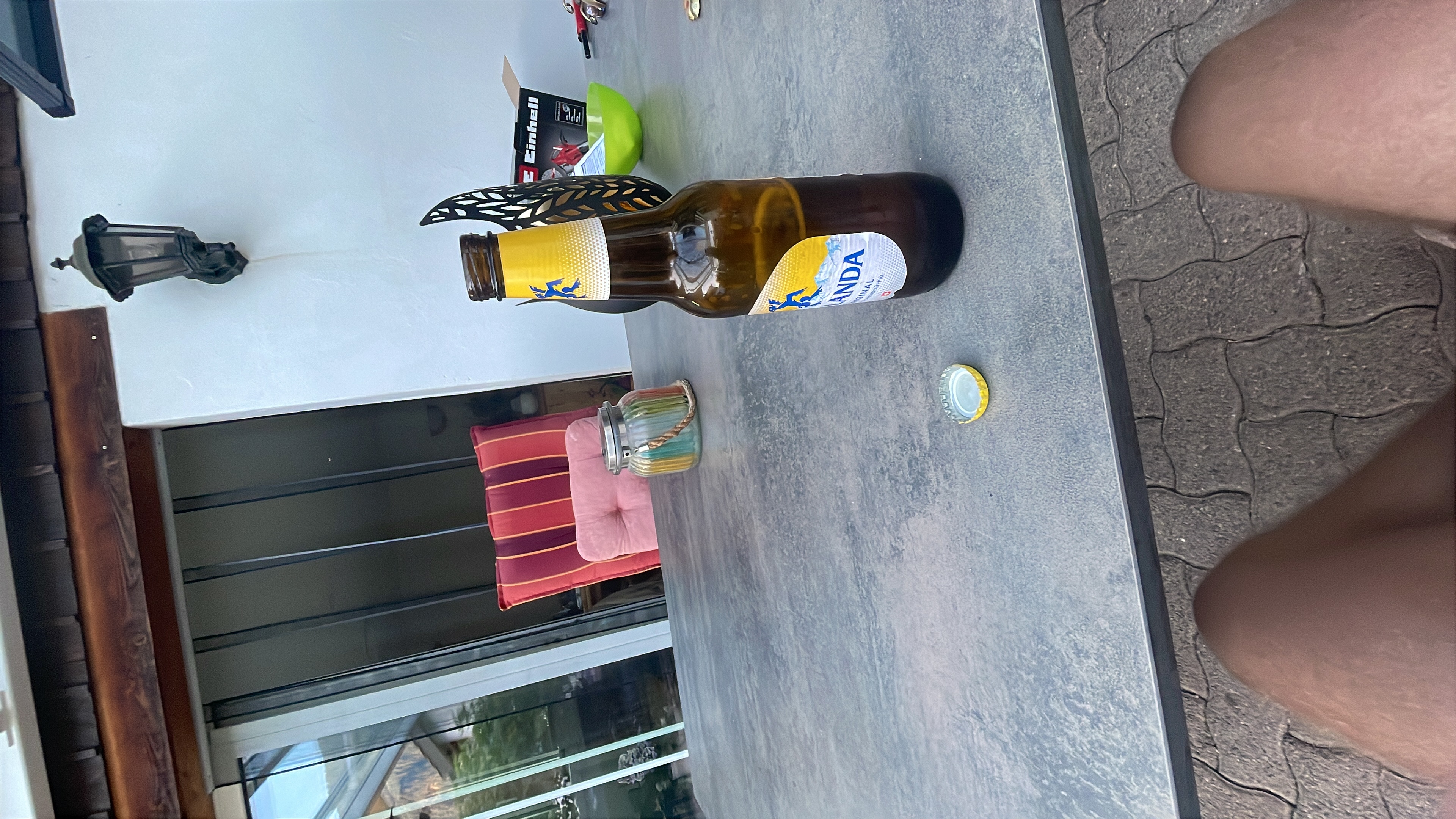A cold Wanda beer on a terrace table – mountains visible in the background after the first day of cycling